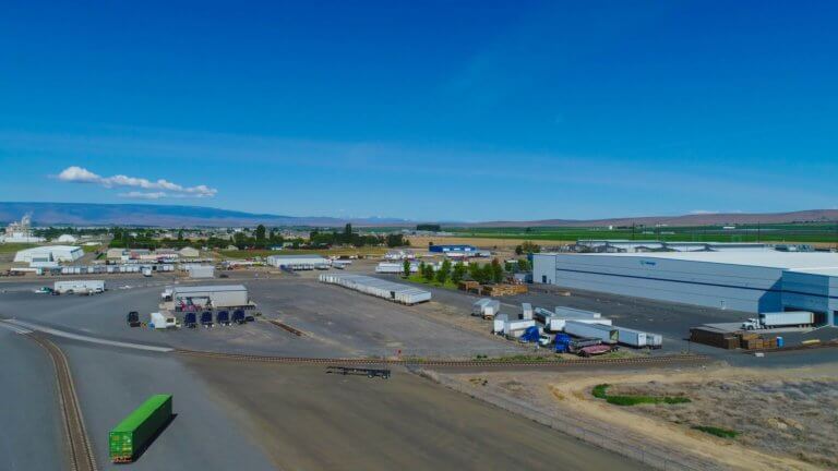 Overhead view of train tracks leading to cargo facility.